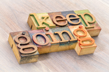 keep going word abstract in wood type