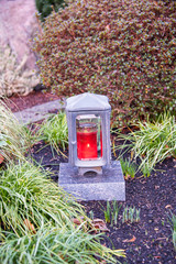 Schöne Grablampe mit roter Kerze