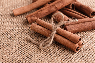 Cinnamon essential oil on a wooden background