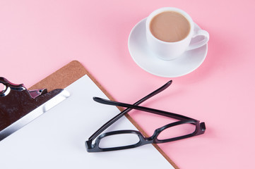 coffee and glasses on a pink background