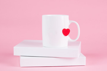 mug of tea with a heart on a pink background