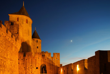 Carcassonne medieval fortress highlighted night view with moon in blue sky