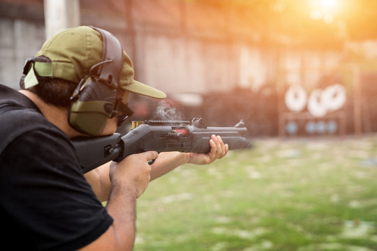 Man shooting on an outdoor shooting range, selective focus