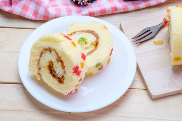 Sliced Cake Roll on wooden background