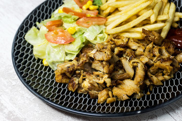 Fresh chicken steak with tomatoes and french fries