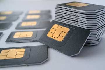 SIM cards for mobile phones in one stack leaning against the stack - obrazy, fototapety, plakaty