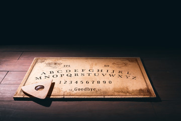Talking board and planchette used on seances for communicating with the dead, high contrast image
