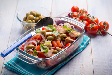 fish salad with swordfish tomatoes and green olives, selective focus