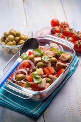 fish salad with swordfish tomatoes and green olives, selective focus
