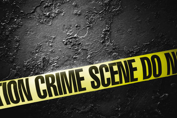 Crime scene tape with a grungy background, high contrast image