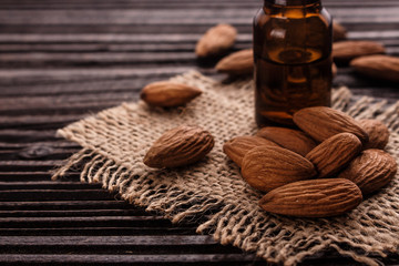 almond essential oil on a wooden background
