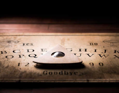 Talking board and planchette used on seances for communicating with the dead, high contrast image