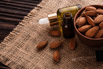 almond essential oil on a wooden background