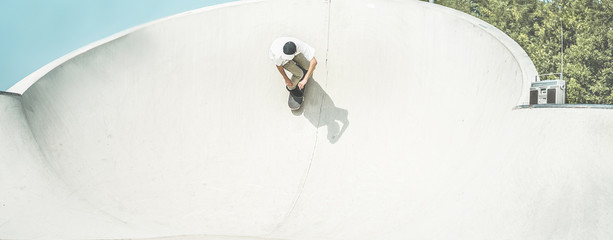 Skater training in skate park - Young man riding skateboard in urban contest - Extreme sport and youth trendy lifestyle © DisobeyArt