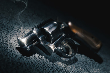 Smoking gun on the floor, high contrast image