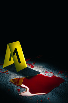 evidence markers on the floor with blood puddle, high contrast image