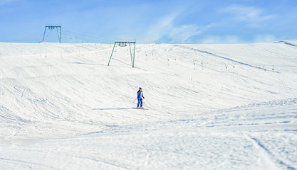 Fototapeta na wymiar Adult athlete skiing in french mountains on sunny day
