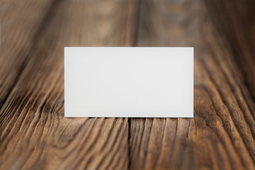 White Blank business card on wooden background. Place for ID