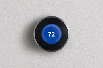 A simplistic photo of a round, modern, programmable digital thermostat in cooling mode, on a clean white wall.	 - obrazy, fototapety, plakaty