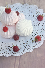 marshmallows with raspberries on a wooden background blurred background 