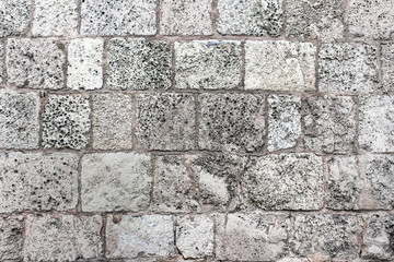 Texture of gray brick wall. Old fashioned natural stone wall texture.