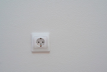 Power socket on plaster background. Place for text or design.