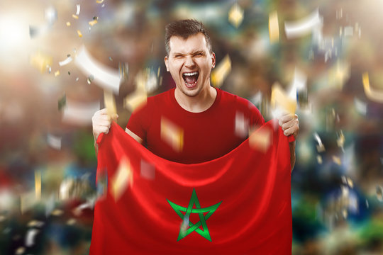 A Moroccan fan, a fan of a man holding a Morocco national flag in his hands. Soccer fan in the stadium. Mixed media