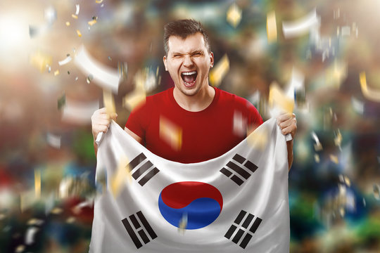 South Korean fan, a fan of a man holding the national flag of South Korea in his hands. Soccer fan in the stadium. Mixed media