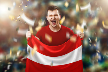 Austrian fan, a fan of a man holding the national flag of Austria in his hands. Soccer fan in the stadium. Mixed media