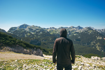 Mountain hiker at high viewpoint looking at the valley