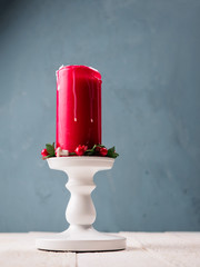 Christmas candle with stand on the wood board