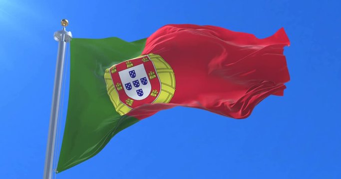 Flag of Portugal waving at wind in slow with blue sky, loop