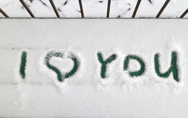 sign of love on a bench in the snow