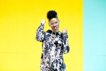 fashion portrait of triumphant young woman with purple lips
