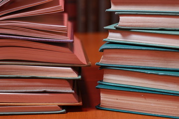 Stacks of colored books on a wooden table. concept of reading habits