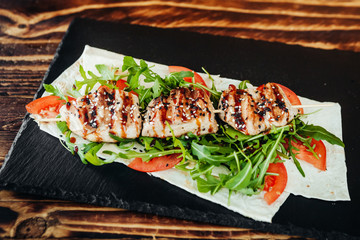 appetizing and delicious grilled meat dish with vegetables and herbs