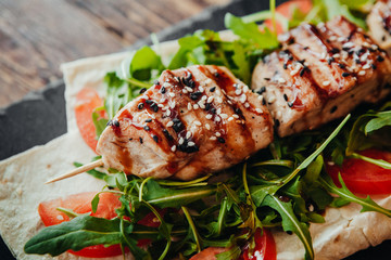 appetizing and delicious grilled meat dish with vegetables and herbs