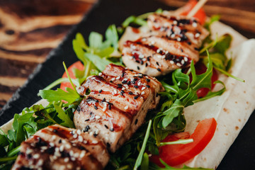 appetizing and delicious grilled meat dish with vegetables and herbs