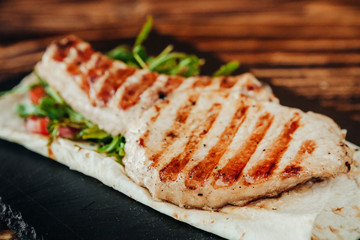 appetizing and delicious grilled meat dish with vegetables and herbs