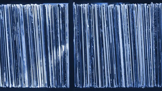 Stack of old vinyl records. Blue tone