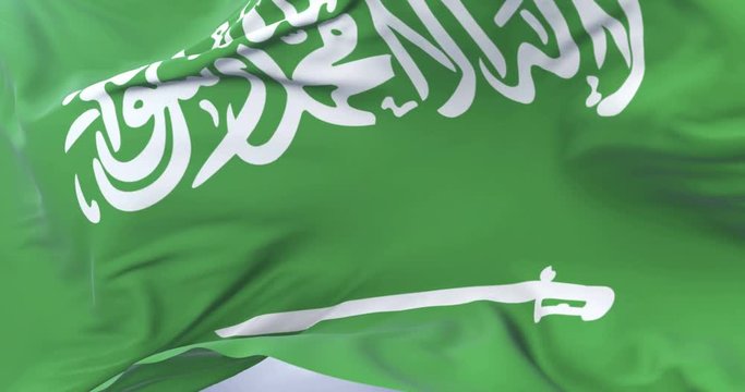 Saudi Arabia flag waving at wind in slow with blue sky, loop