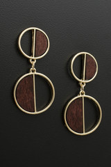 Fototapeta na wymiar gold earrings with wooden insets, isolated on black