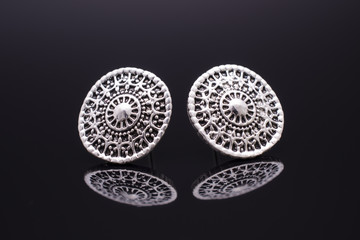 silver stud earrings isolated on black