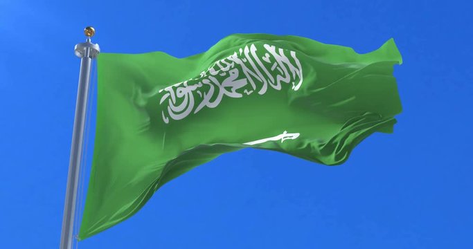 Flag of Saudi Arabia waving at wind in slow with blue sky, loop