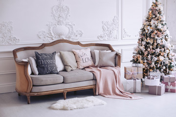 New Year's interior with a beautiful decorative tree and gift boxes