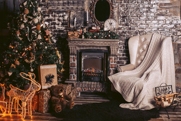 New Year's interior with a warm fireplace, a Christmas tree and decorative elements in dark colors