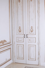 White retro door with decorative gold elements