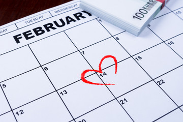 February 14 marked on the calendar and the money set aside for gifts.