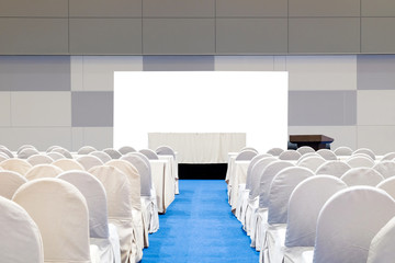 Close-up empty meeting room with stage, table, isolated on white background, podium and chairs for business conference seminar.
