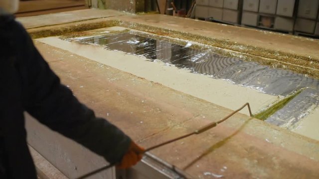 hot dip galvanizing. Industrial worker against the background of a bath with liquid zinc